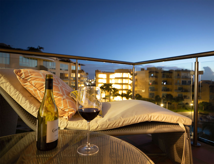 Balcony with a glass of wine at a luxury hotel in Aruba